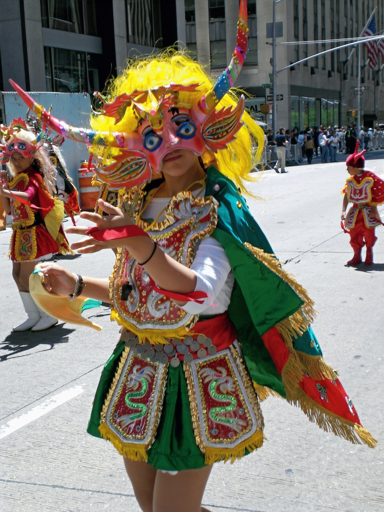 Diablada dancer in colorful costume at the Immigrants Parade